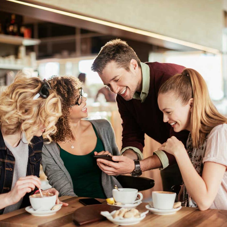 people using digital jukebox app at bar